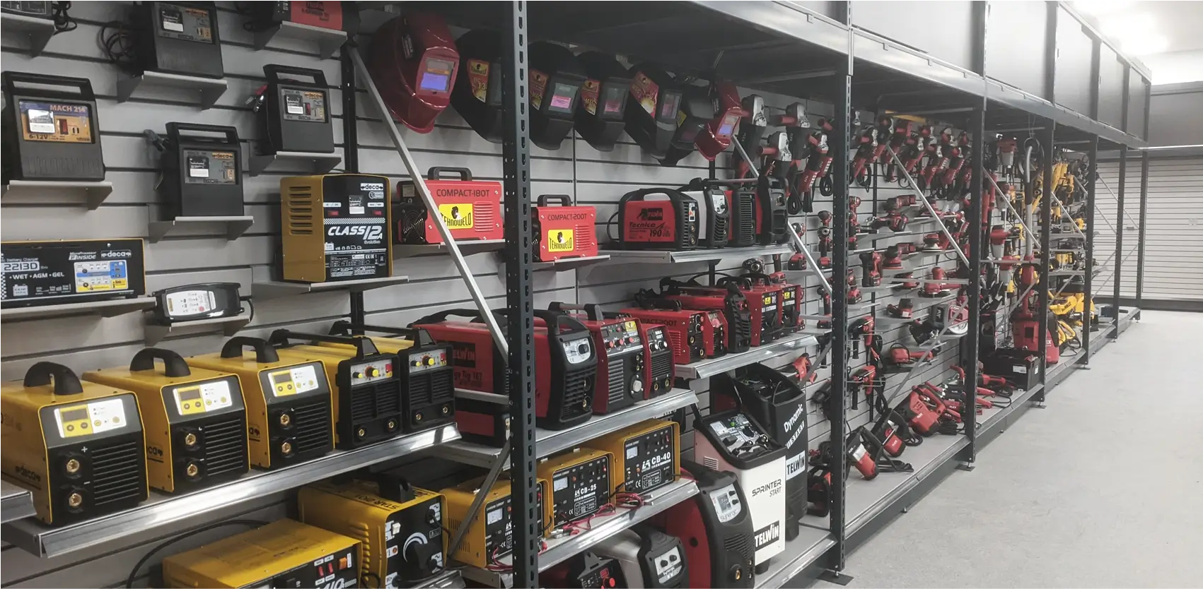 Estanterías metálicas industriales para exhibición de herramientas eléctricas y equipos de soldadura en ferretería o tienda de construcción